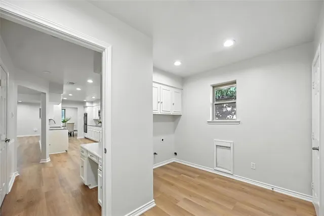 a view of a kitchen and an empty room