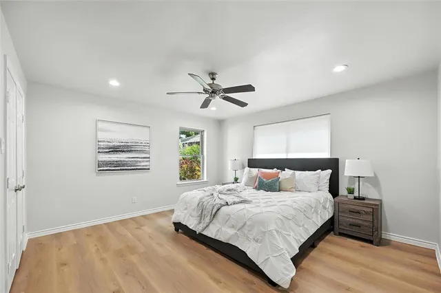 a bedroom with a large bed and a window