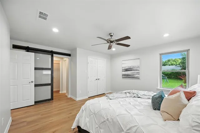 a bedroom with a bed and a window