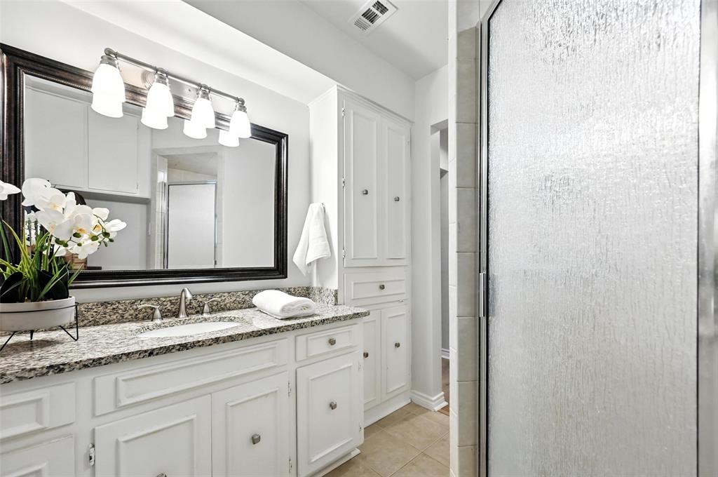7407 Authon Drive Dallas, TX 75248 - Photo 19 of 31 a bathroom with a granite countertop sink and a mirror