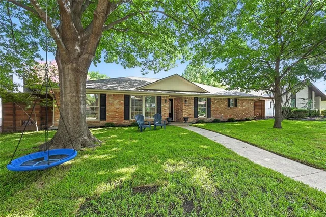 a front view of a house with a yard and porch