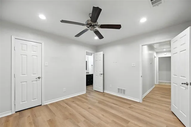 a view of an empty room and wooden floor