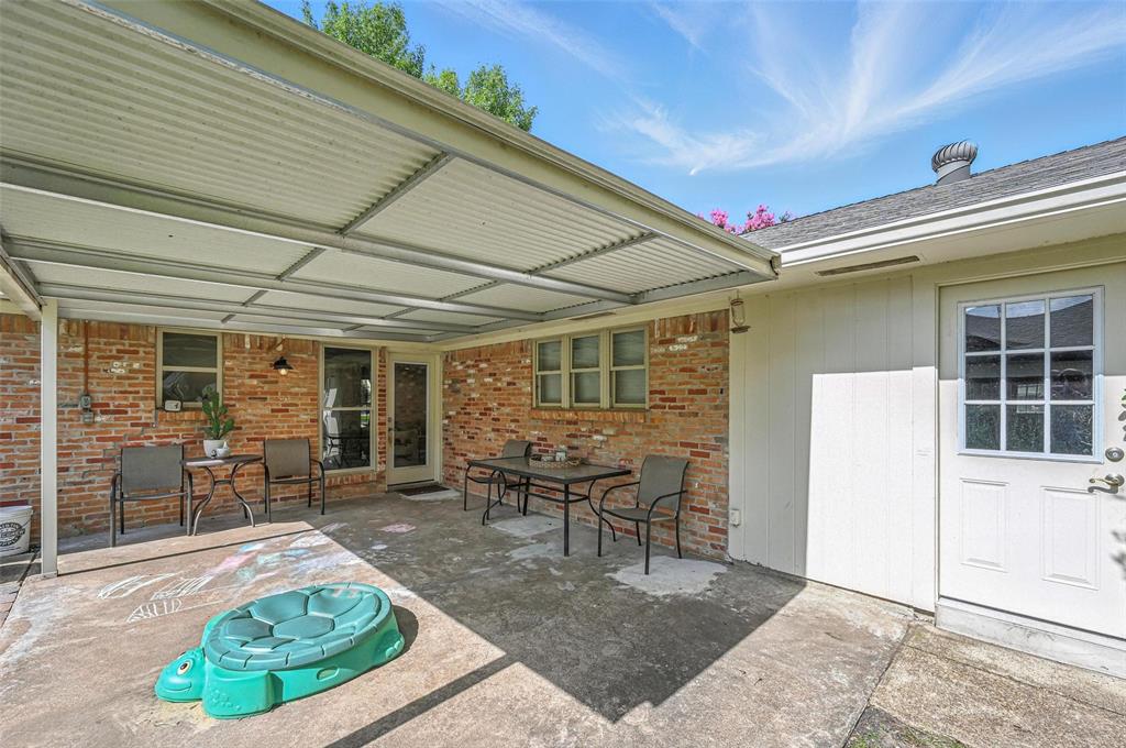 7407 Authon Drive Dallas, TX 75248 - Photo 29 of 31 a view of a patio with table and chairs and potted plants