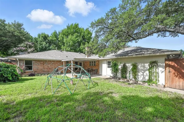 a view of a house with a yard and sitting area