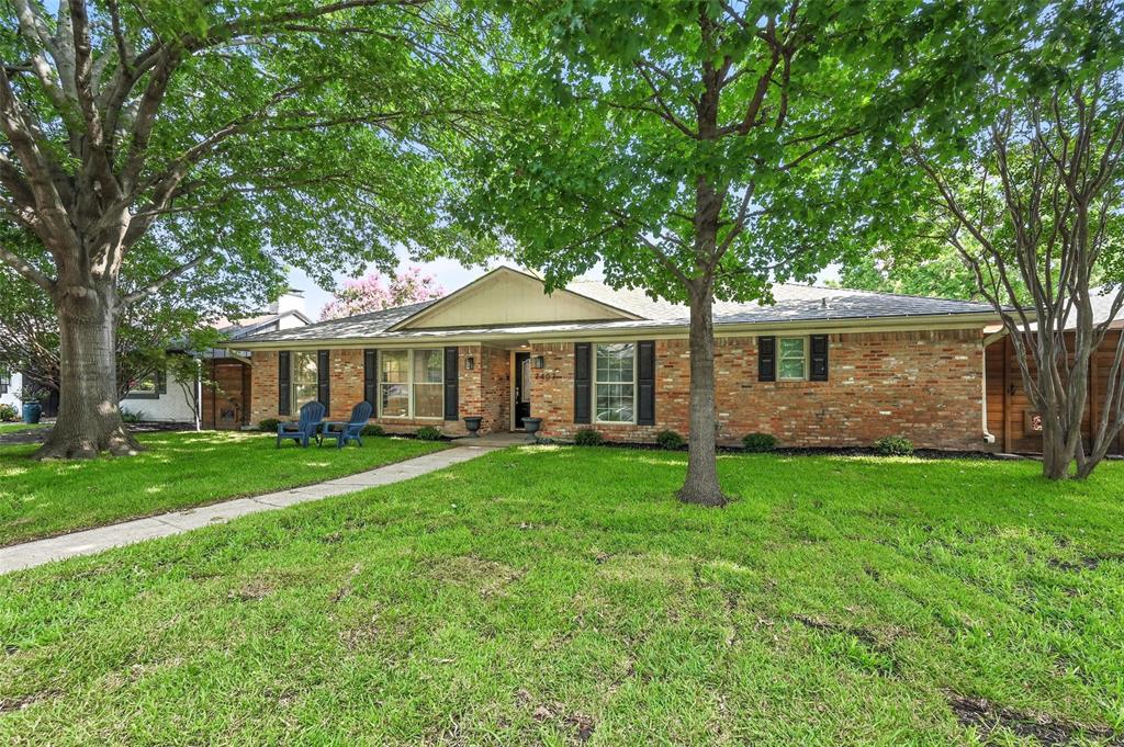 7407 Authon Drive Dallas, TX 75248 - Photo 3 of 31 a front view of a house with a garden