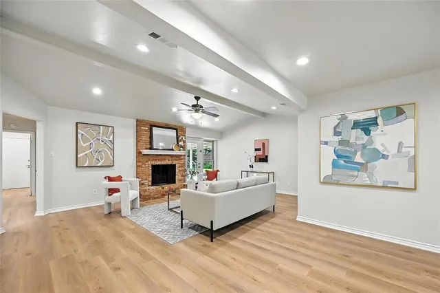 a living room with fireplace furniture and a flat screen tv