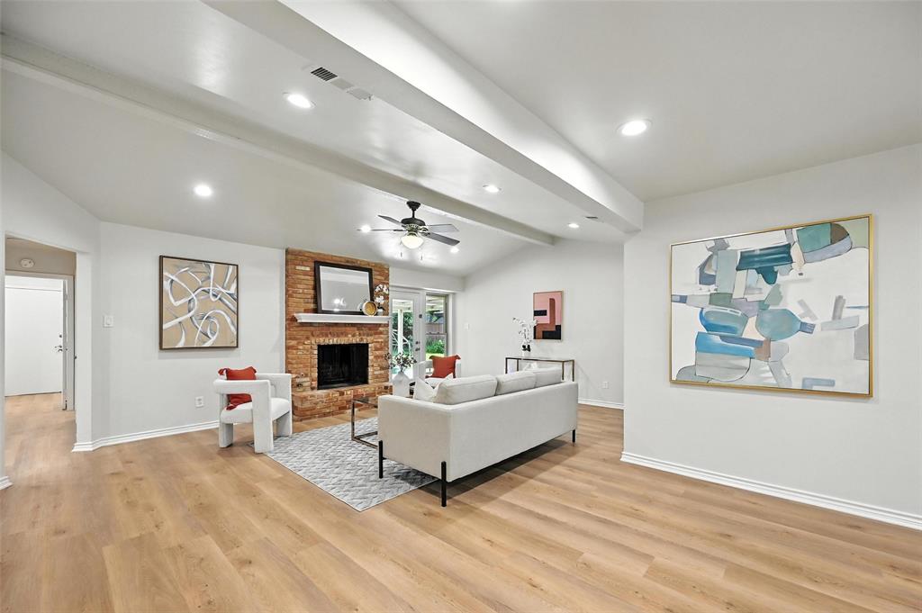 7407 Authon Drive Dallas, TX 75248 - Photo 5 of 31 a living room with fireplace furniture and a flat screen tv