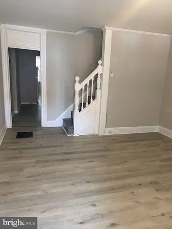 a view of an empty room with wooden floor