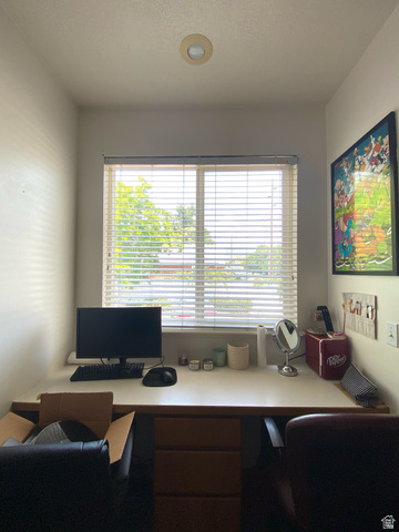 677 300 North, Unit 7 Provo, UT 84606 - Photo 13 of 16 Built-in desk with three drawers beneath a window, featuring integrated blinds and a recessed ceiling light