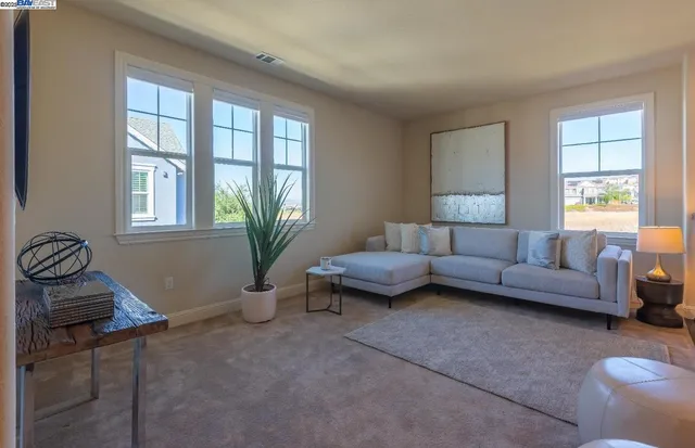 a view of a hallway with furniture and a livingroom view