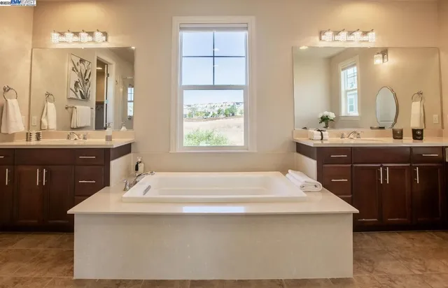 a spacious bathroom with a sink double vanity and a mirror