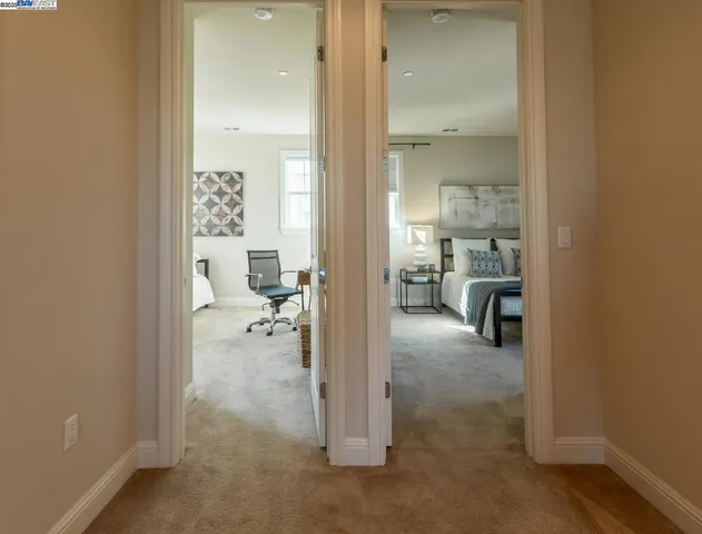 a bedroom with a bed table chair and a window