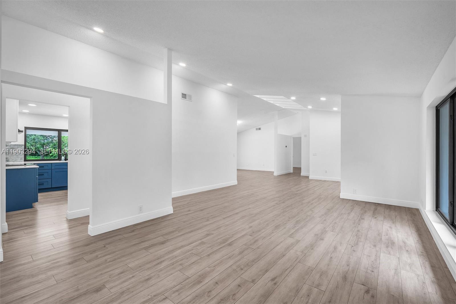 11476 Sundance Lane Boca Raton, FL 33428 - Photo 11 of 45 a view of a big room with wooden floor and windows