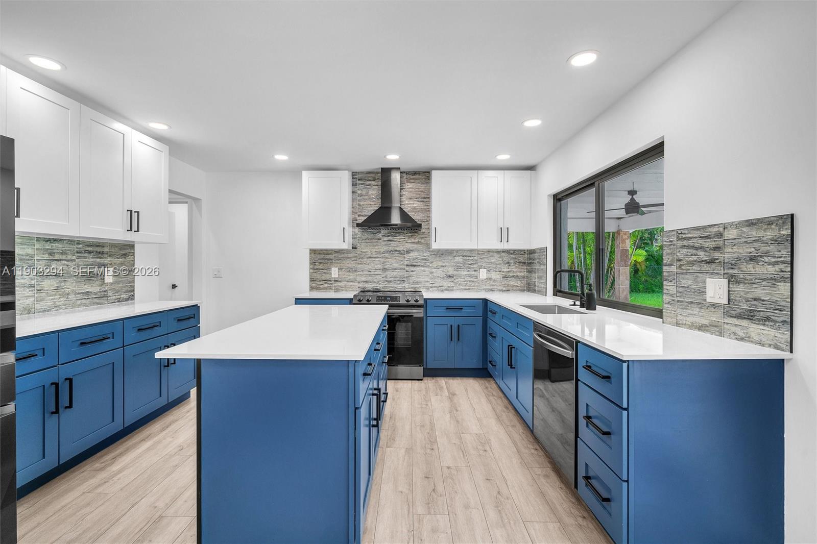 11476 Sundance Lane Boca Raton, FL 33428 - Photo 16 of 45 a kitchen with stainless steel appliances kitchen island granite countertop a sink stove and refrigerator