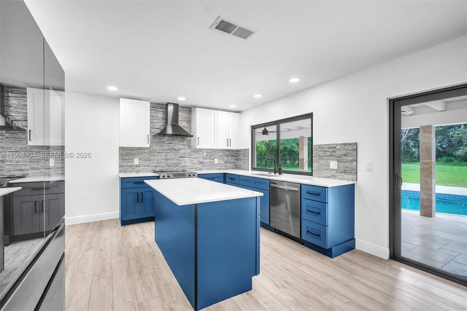 11476 Sundance Lane Boca Raton, FL 33428 - Photo 17 of 45 a kitchen with stainless steel appliances granite countertop wooden cabinets a sink and a stove
