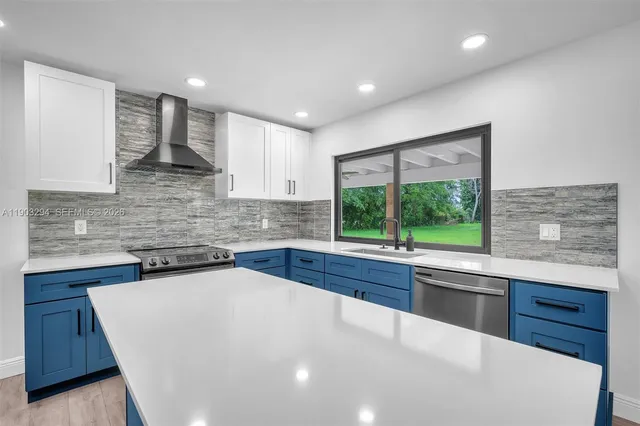 a kitchen with stainless steel appliances a sink stove and cabinets