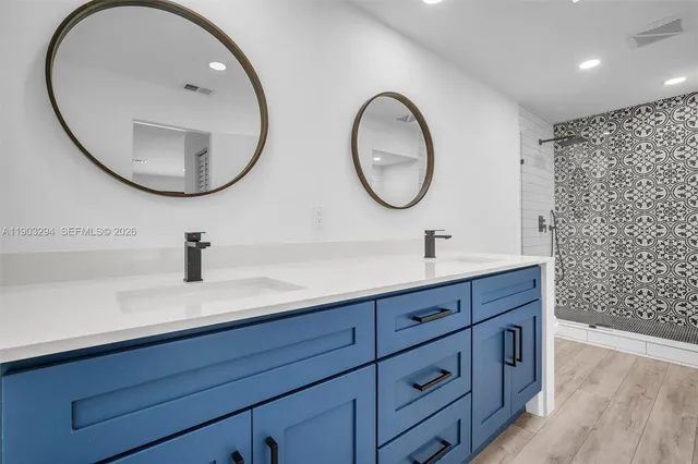 a bathroom with a double vanity sink and a mirror
