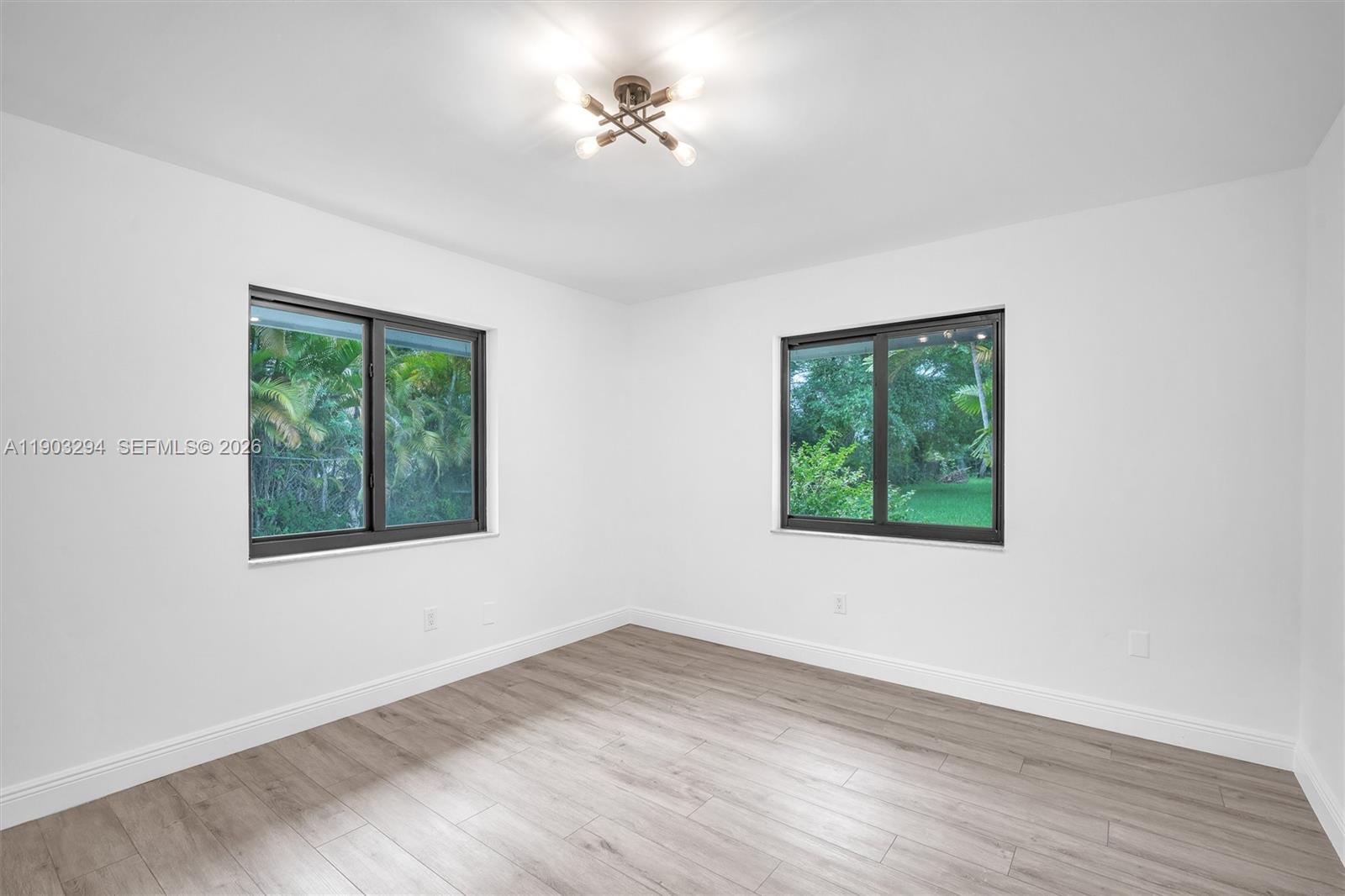 11476 Sundance Lane Boca Raton, FL 33428 - Photo 28 of 45 a view of an empty room with a window and wooden floor