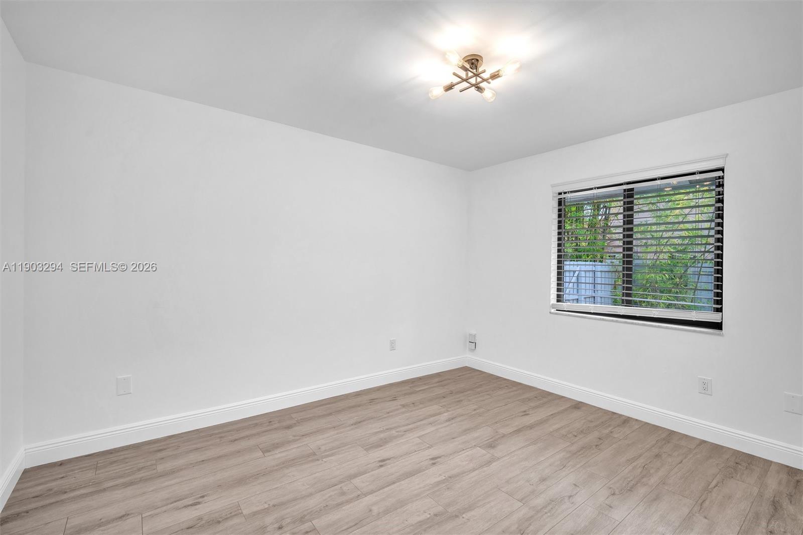 11476 Sundance Lane Boca Raton, FL 33428 - Photo 29 of 45 a view of empty room with wooden floor and fan