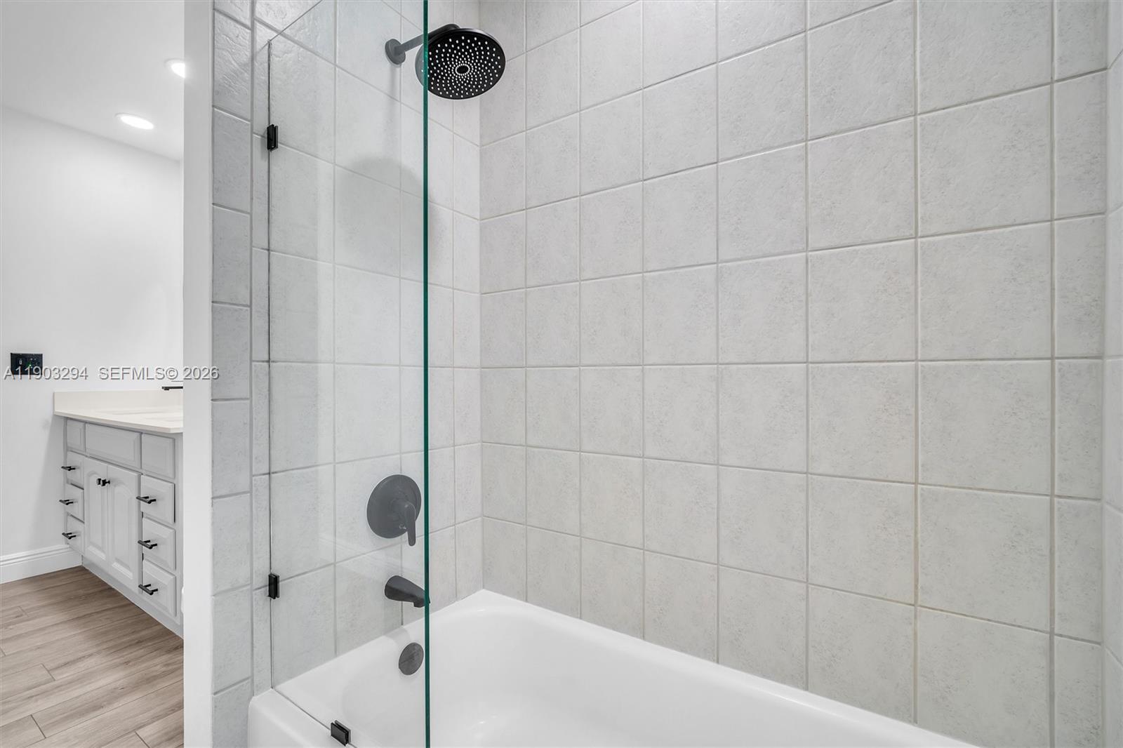 11476 Sundance Lane Boca Raton, FL 33428 - Photo 31 of 45 a bathroom with a bathtub and a shower