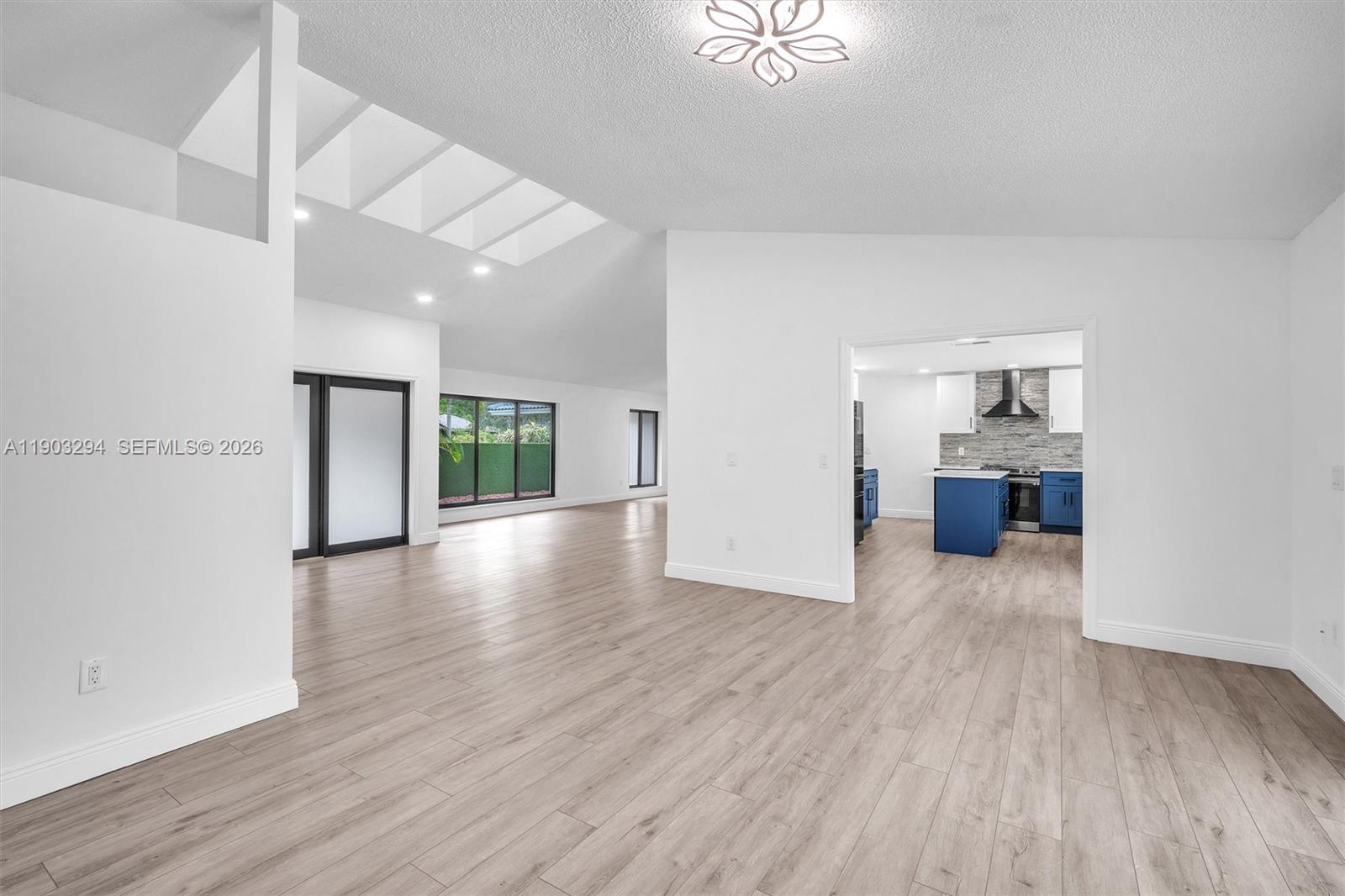 11476 Sundance Lane Boca Raton, FL 33428 - Photo 8 of 45 an empty room with wooden floor and windows