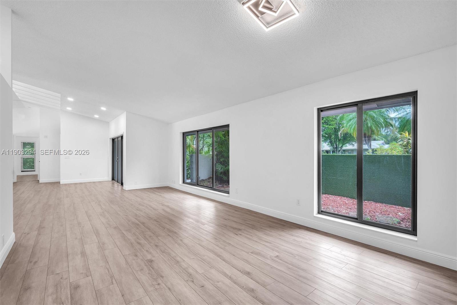 11476 Sundance Lane Boca Raton, FL 33428 - Photo 9 of 45 a view of empty room with wooden floor and fan