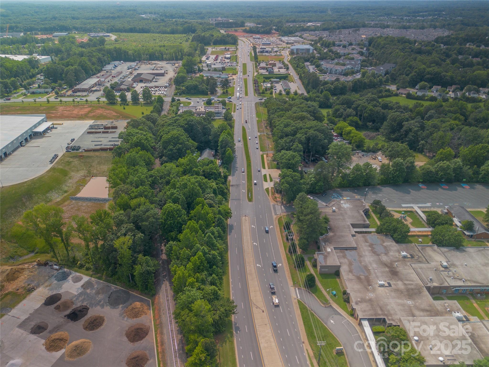 13428 Albemarle Road Charlotte, NC 28227 - Photo 4 of 5 an aerial view of residential houses with outdoor space