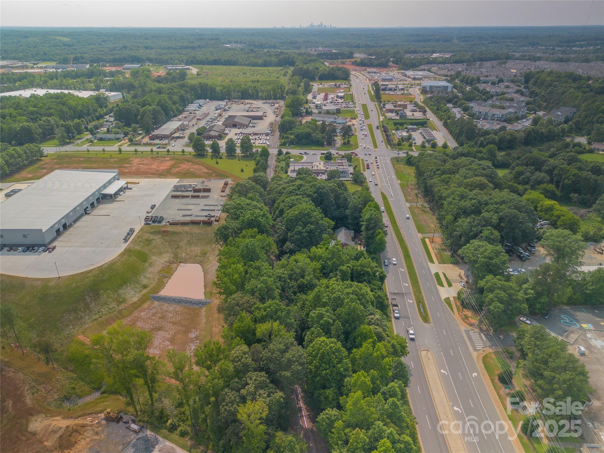 13428 Albemarle Road Charlotte, NC 28227 - Photo 5 of 5 an aerial view of residential houses with outdoor space and river