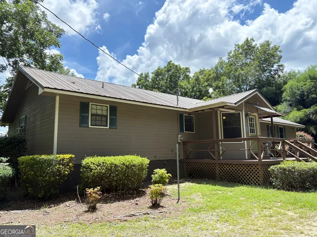 a kitchen with stainless steel appliances a refrigerator a stove top oven a sink dishwasher and wooden cabinets