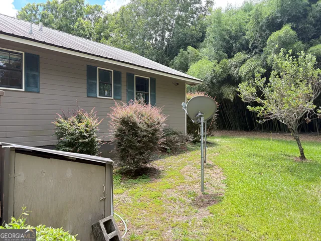 a view of a livingroom with furniture hardwood floor and staircase