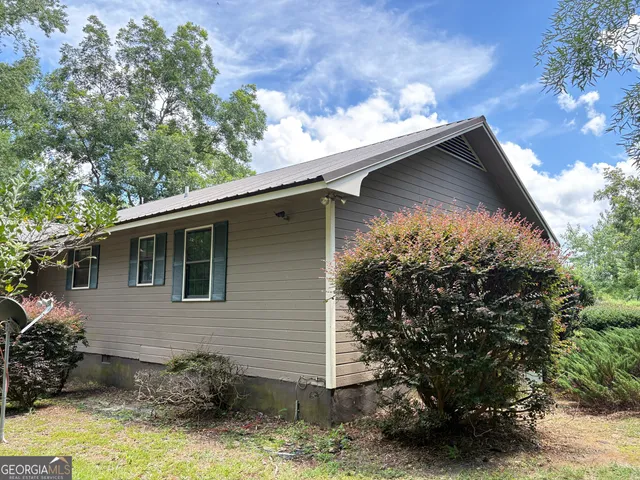 a bathroom with a sink and mirror with toilet