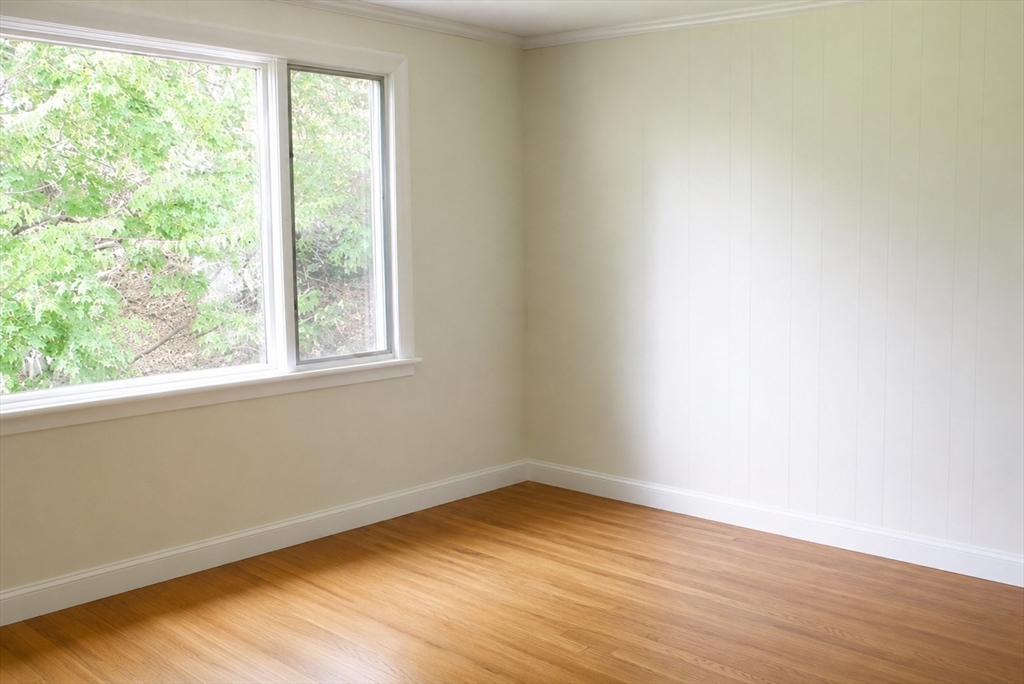 132 Brandeis Road Newton, MA 02459 - Photo 8 of 10 an empty room with wooden floor and windows