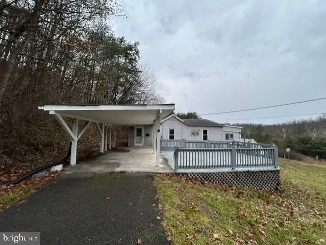 a view of a house with a large window and wooden fence