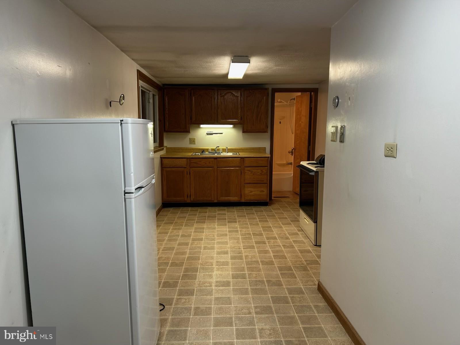 22704 Oldtown Road Southeast Oldtown, MD 21555 - Photo 2 of 15 a room with a refrigerator and a stove