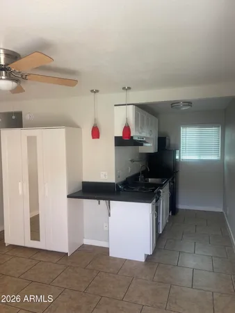 a kitchen with granite countertop a stove and a refrigerator