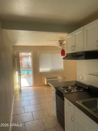 a kitchen with a sink and a stove top oven