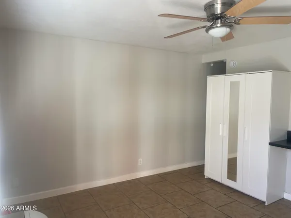 a view of a room that has a window and a chair