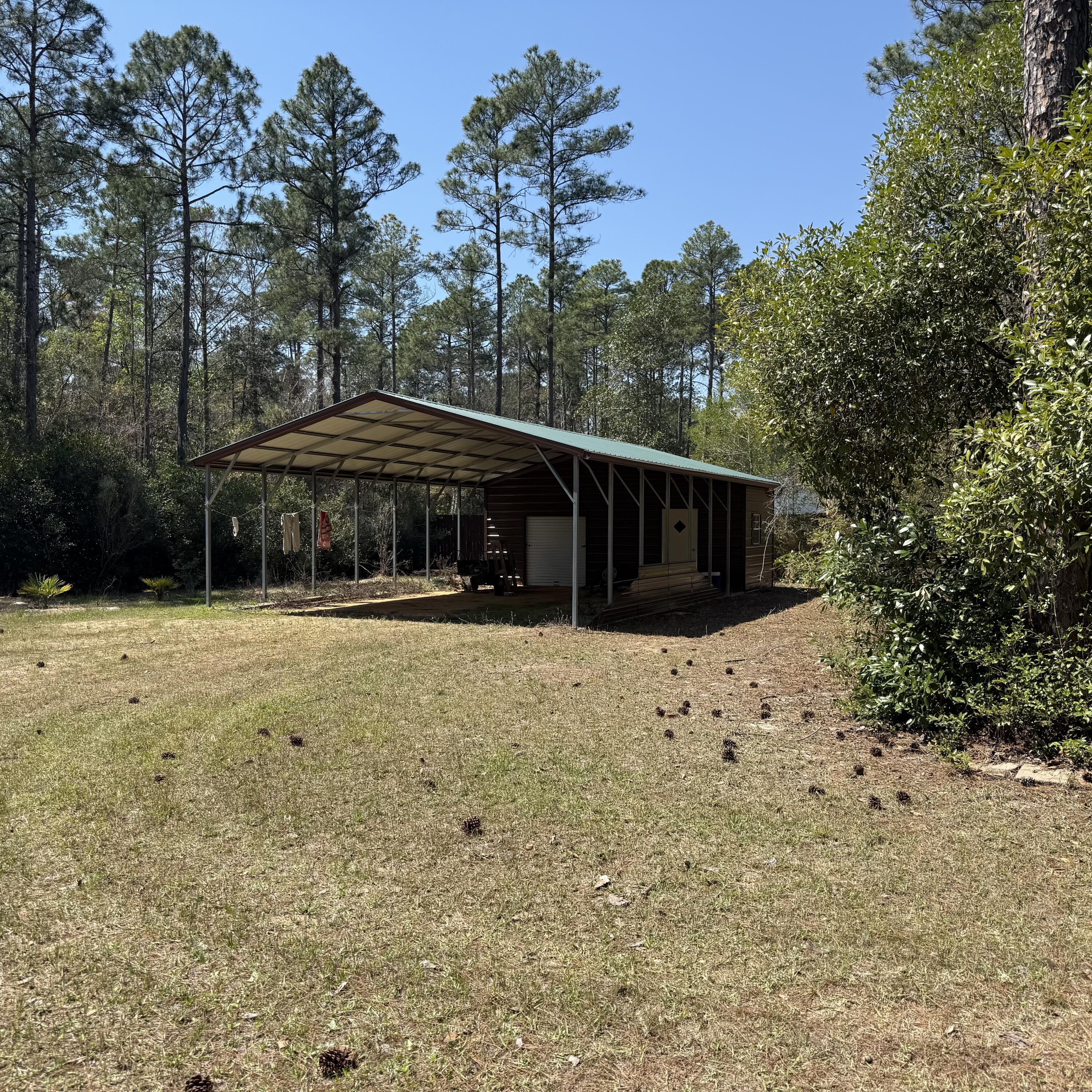 Tbd Mallet Road Freeport, FL 32439 - Photo 7 of 10 a house with trees in the background