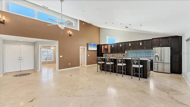 a view of a livingroom with a ceiling fan and window