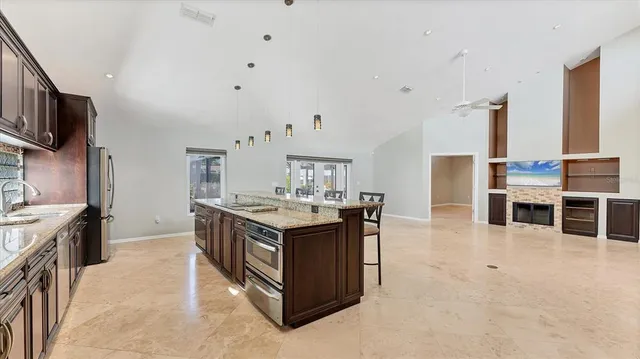 an empty room with a chandelier fan and a window