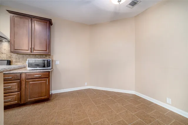a kitchen with granite countertop a sink and cabinets