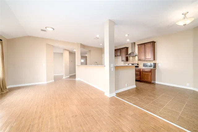 a view of a kitchen with a sink and a refrigerator