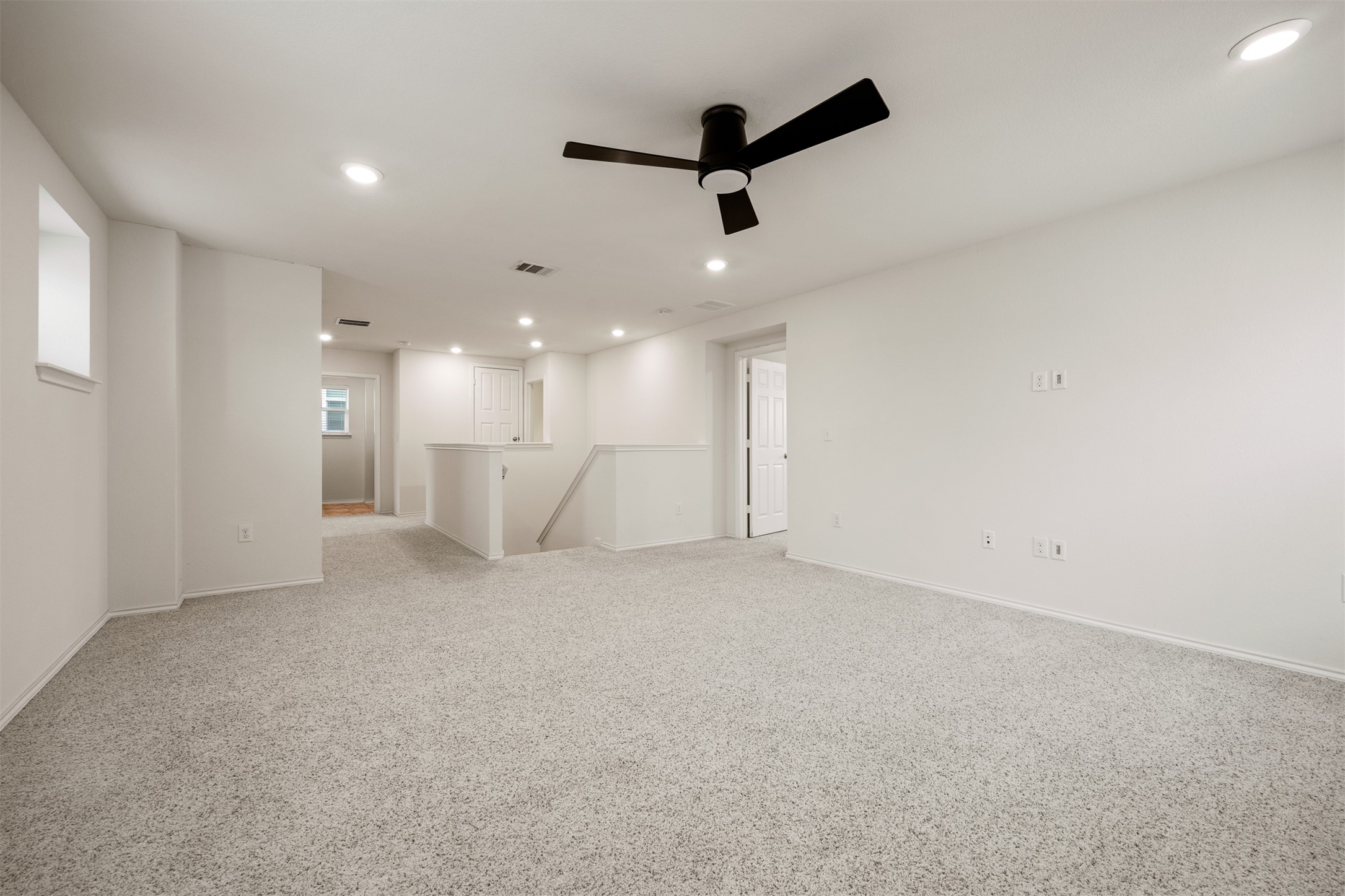 7009 Nutria Run Austin, TX 78744 - Photo 8 of 15 A spacious, naturally illuminated room featuring plush carpeting and modern recessed lighting.