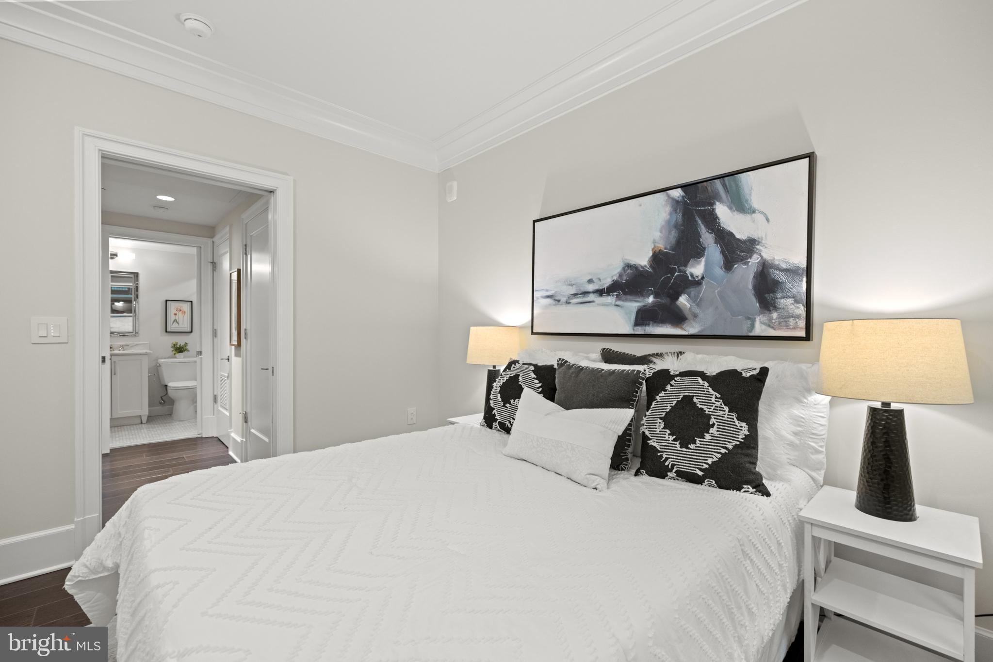 1108 16th Street Northwest, Unit 504 Washington, DC 20036 - Photo 11 of 22 a bedroom with a bed and a painting on the wall