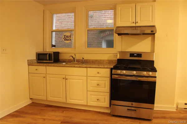 a kitchen with stainless steel appliances granite countertop a stove and a sink