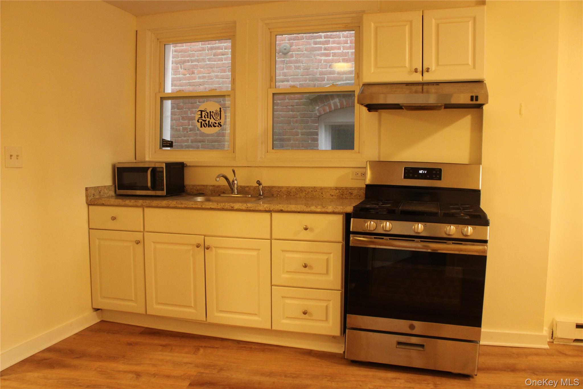 52 South Bridge Street, Unit 1 Poughkeepsie, NY 12601 - Photo 15 of 27 a kitchen with stainless steel appliances granite countertop a stove and a sink