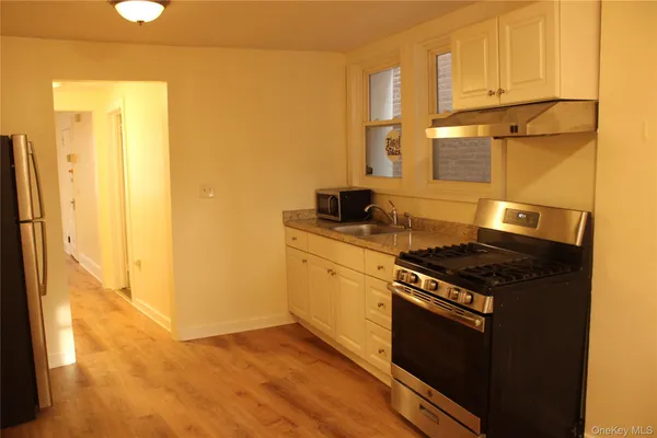 a kitchen with stainless steel appliances granite countertop a stove and a refrigerator