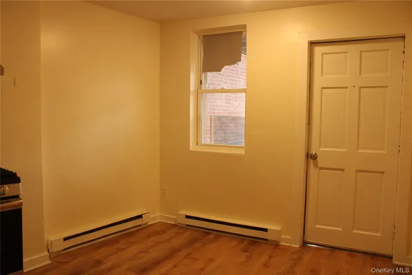 an empty room with wooden floor and closet