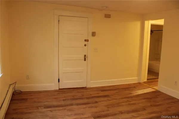 an empty room with wooden floor and closet
