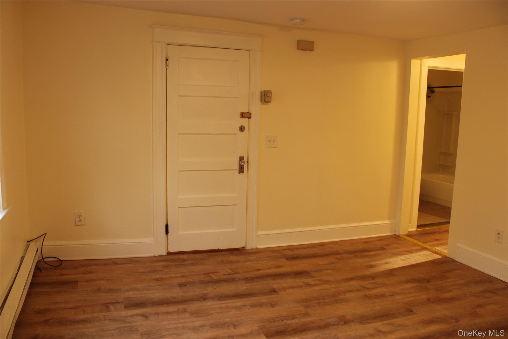 52 South Bridge Street, Unit 1 Poughkeepsie, NY 12601 - Photo 5 of 27 an empty room with wooden floor and closet